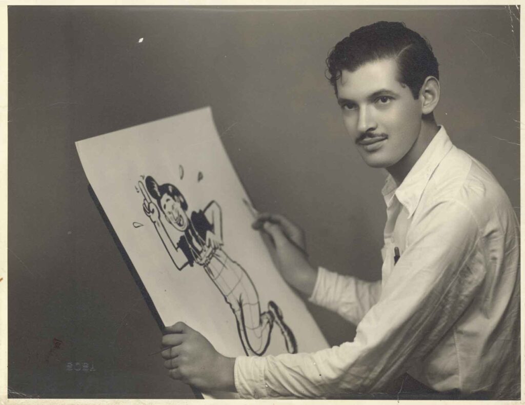 Abel Quezada, joven, sosteniendo uno de sus dibujos